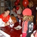 Kelli__Barnhart_signing_ball__Hanah_waiting.JPG